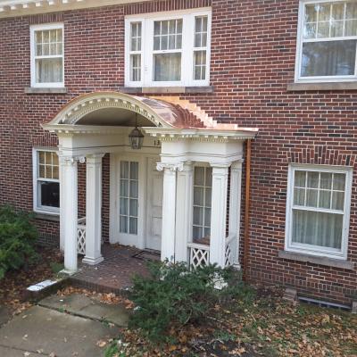 Hazlett Roofing and Restoration worked to remove years of tar to return the copper entryway to its original appearance