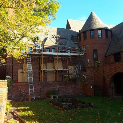 Careful installation of some complicated flashing in a long curved valley behind the turret